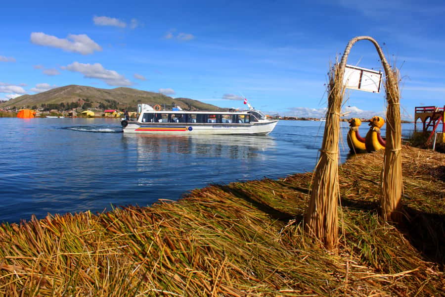 From Puno: Uros floating islands half Day tour - The optional handmade boat ride